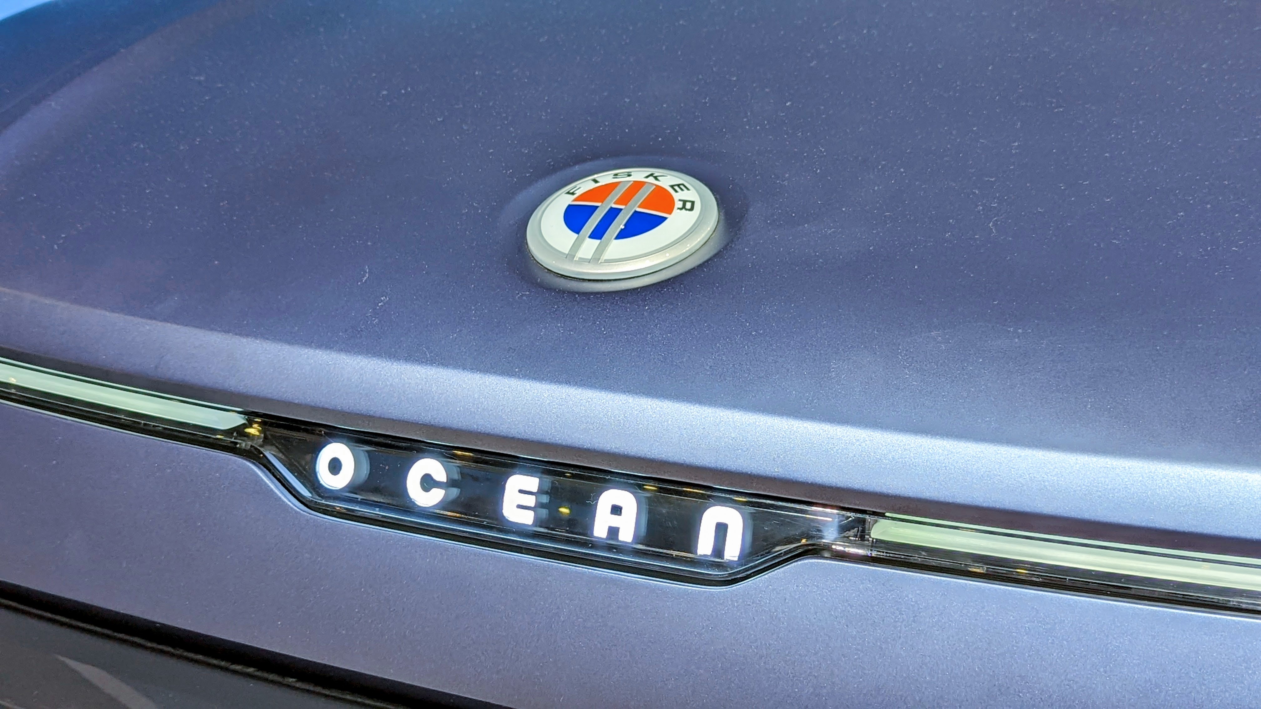 Close up of illuminated Ocean badge on front of car